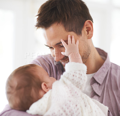 Buy stock photo Love, father and baby with happiness in home for bonding, comfort or playing together for healthy development. Family, man and newborn child with smile, embrace and relax for parenting, care or touch