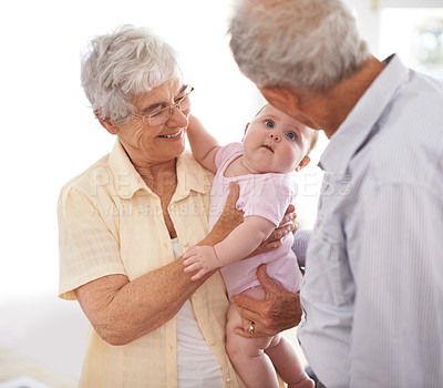 Buy stock photo Grandparents, baby and family for love and bonding, happy old people at home and connect with infant for relationship. Pride, positive and care with retirement and newborn for joy and fun together