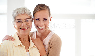 Buy stock photo Portrait of a smiling young woman and her senior mother bonding