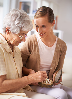 Buy stock photo Cropped shot of a senior woman giving her daughter a pearl necklace