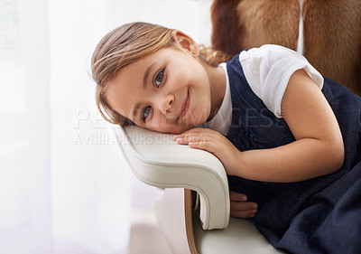 Buy stock photo Girl, child and portrait with rest on chair in living room of home for relax, break and smile with confidence. Young person, kid and face or happy in lounge for wellness, holiday and weekend vacation