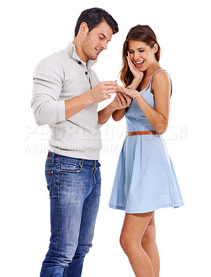 Buy stock photo Happy, couple and ring with engagement announcement, news and yes to commitment and marriage. Proposal, excited and smile in studio with love, jewellery and romance with white background and question