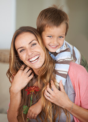 Buy stock photo Portrait, mother and son with smile on piggyback for mothers day, bonding and together inside. Happy woman, boy and laugh with flower, hug and love for playful weekend in family home New Zealand