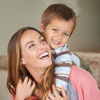 Buy stock photo Shot of a little boy embracing his mother from behind