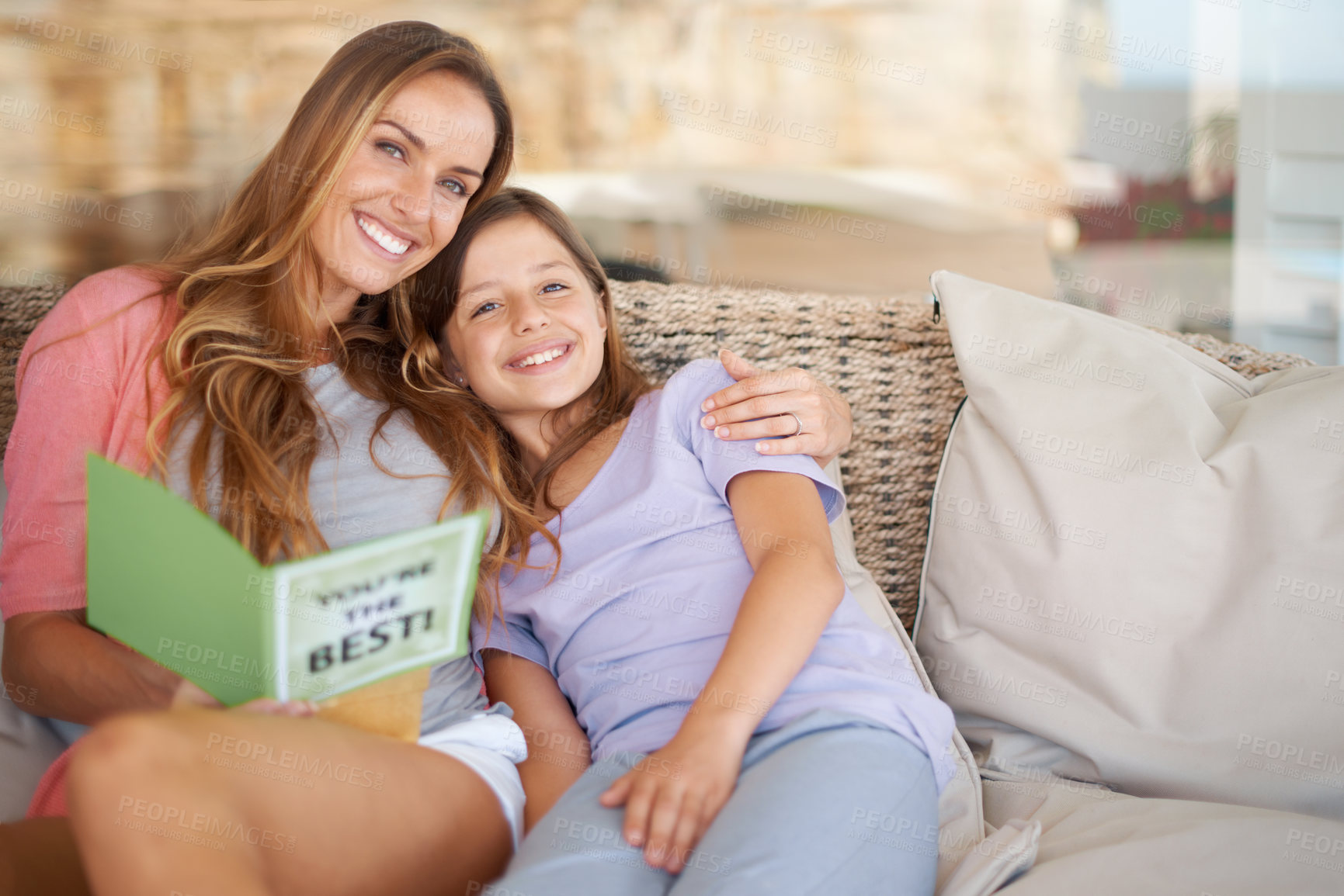 Buy stock photo Mothers day, portrait and card with child, hug and love together with a smile, gift and holiday. Family, girl and mom with support and bonding on a living room sofa with a present and card in home