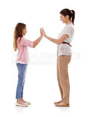 Buy stock photo Mother, child and clapping game for bonding and fun together in studio, happy and playful on white background. Woman, young girl and hands together, playing with high five and family time for love