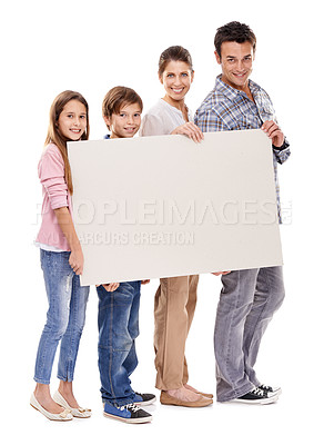 Buy stock photo Parents, kids and studio with empty poster in portrait with smile for bonding, love and space by white background. Mother, father and children with mockup, promotion and happy together with family