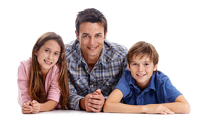 Buy stock photo Floor, white background and portrait of father with children for bonding, relax together and love. Family, parenthood and happy dad, girl and boy with smile for connection, care and trust in studio