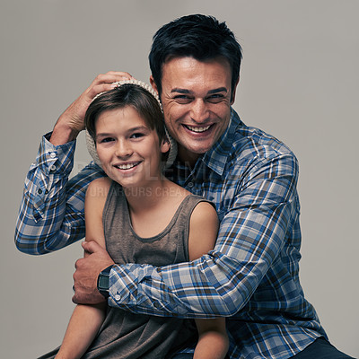 Buy stock photo Studio shot of a trendy father and son against a gray background