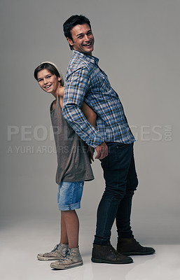 Buy stock photo Boy, father and happy for portrait in studio with laughing, fashion and lean on back by background. Dad, son or child with trust, bonding and connection with love in family, together and comic joke