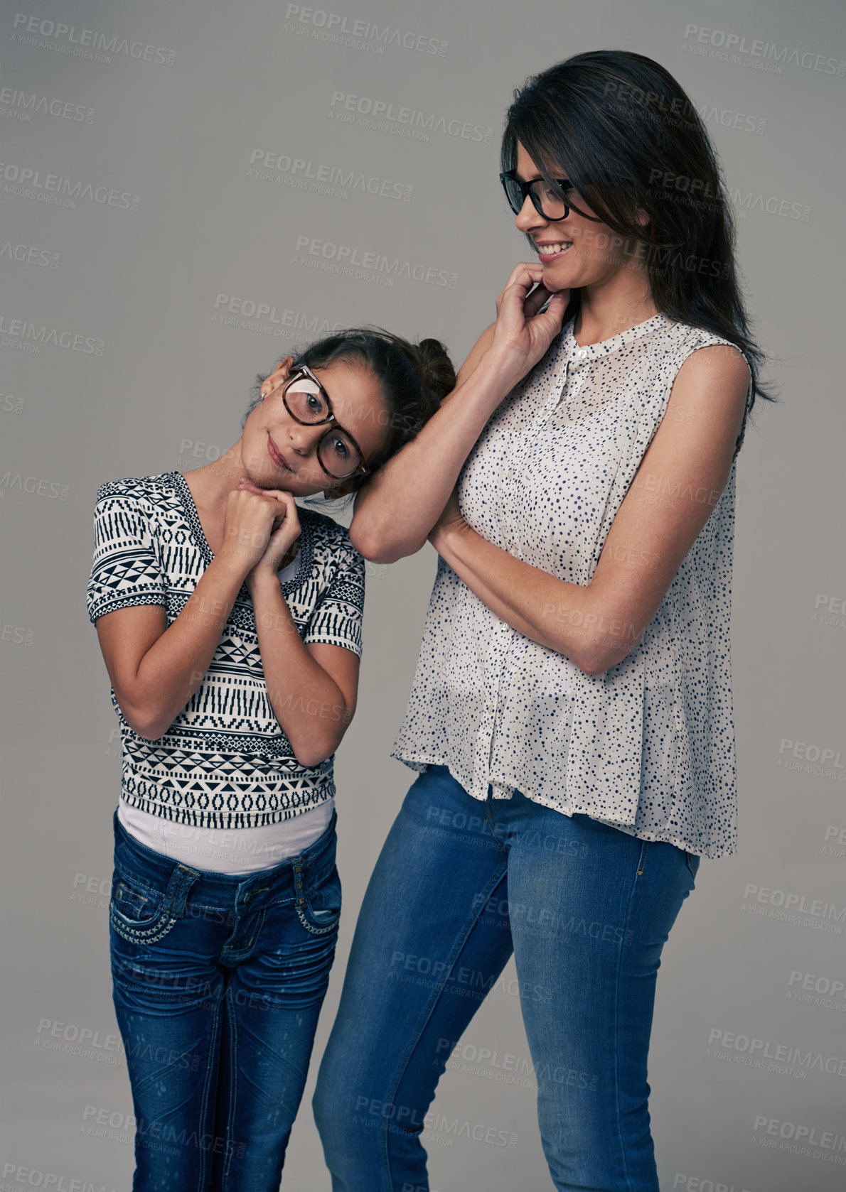 Buy stock photo Happy mother, child and fashion with style for love, growth or support on a gray studio background. Mom, kid or daughter with smile and glasses of smart family in denim jeans and casual clothing