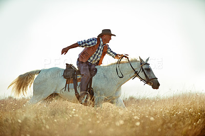 Buy stock photo A cowboy on his horse