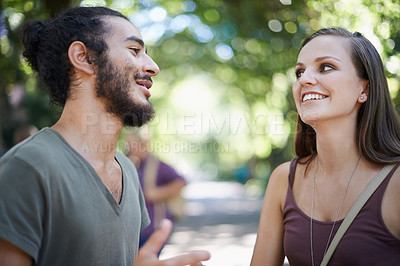 Buy stock photo Cropped shot of a male and female student chatting on campus