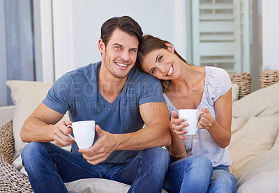 Buy stock photo Happy couple, coffee and sofa with love for morning, bonding or weekend together at home. Face of young man and woman with smile, cup of tea or cappuccino for support, care or trust at apartment