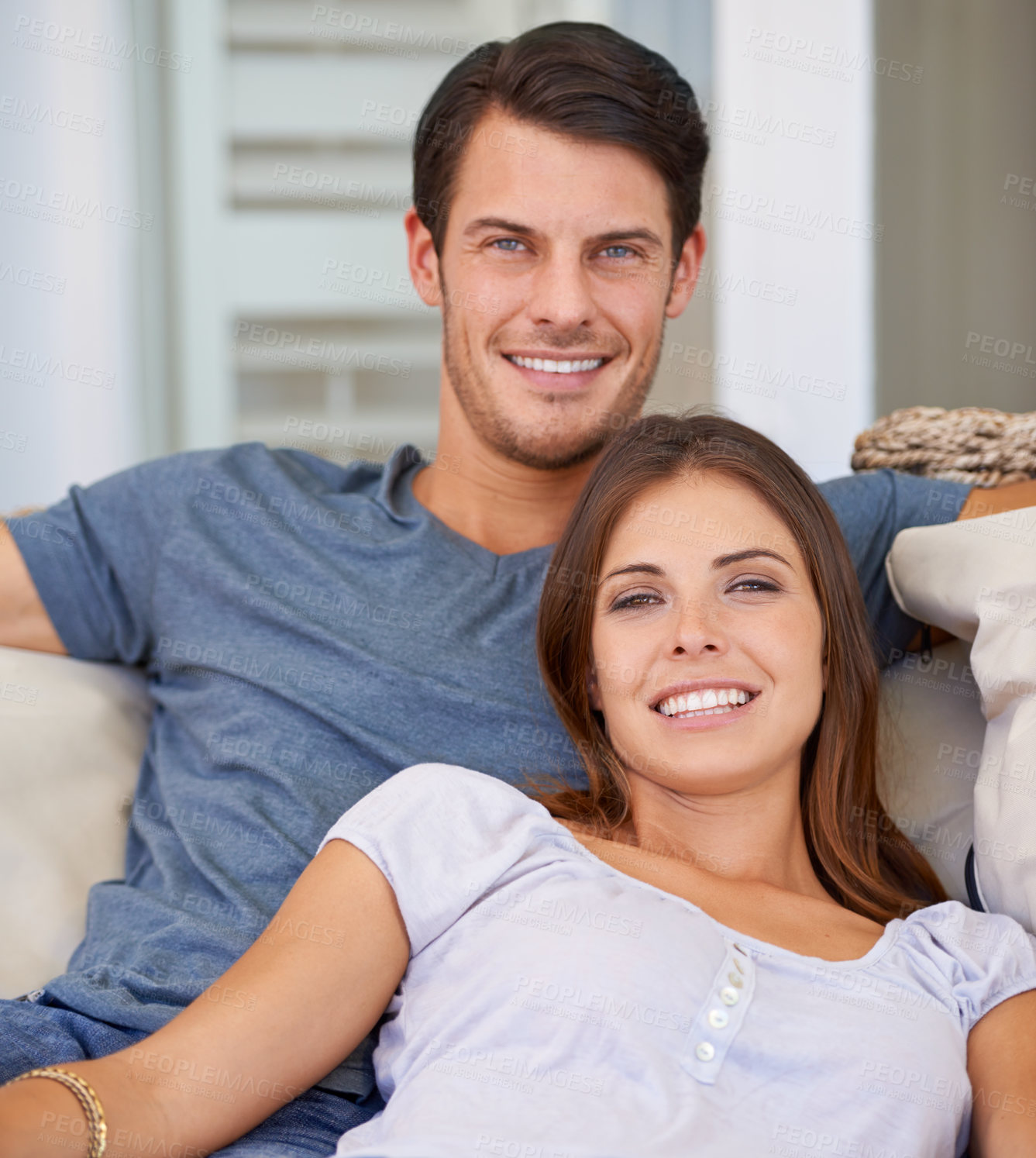 Buy stock photo Happy, sofa and portrait of couple in home for bonding, relationship and relax together. Love, dating and man and woman embrace, hug and smile on couch for support, care and commitment in living room