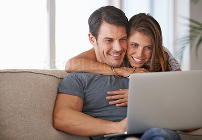 Buy stock photo Laptop, smile and woman embracing man on sofa networking on social media, website or internet. Happy, love and female person hugging husband reading online blog with computer in living room at home.
