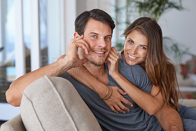 Buy stock photo Happy couple, portrait and love with hug on sofa for care, support or trust in relax together at home. Young man and woman with smile for relationship, holiday or weekend in living room at house