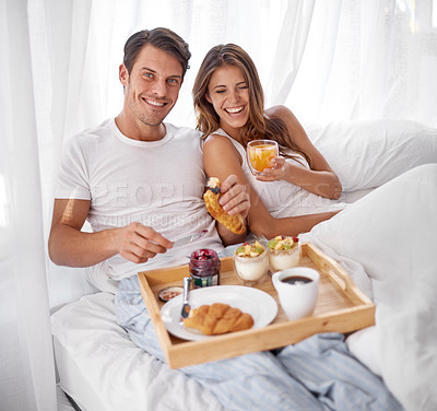 Buy stock photo Breakfast, morning and couple laughing portrait with love, care and food together in home bed. Happiness, smile and relax young people eating and drinking in a house for anniversary or valentines day