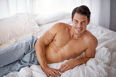 Buy stock photo Sexy, happy and portrait of a man on a bed for relaxing, comfort and rest in pyjamas. Comfy, cozy and handsome young man content in the bedroom, smiling and confident to relax on the weekend