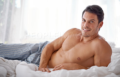 Buy stock photo Sexy, smile and portrait of a man on a bed for relaxing, comfort and rest in pyjamas. Comfy, cozy and handsome young man content in the bedroom, smiling and confident to relax on the weekend