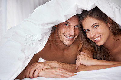 Buy stock photo Love, portrait and couple in bed, waking up and bonding in a bedroom together, flirting and romantic. Face, man and woman relax, intimate and resting at hotel for valentines day, anniversary or bond