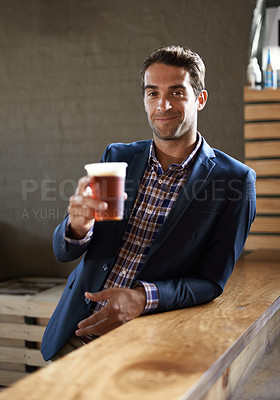 Buy stock photo Professional man at pub, happy with beer in portrait and cheers, relax and leaning against countertop in bistro. Hospitality industry, male business person at restaurant with alcohol drink and smile