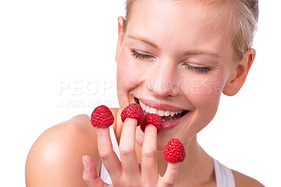 Buy stock photo Smile, funny and woman eating raspberries, fingers and wellness isolated on white studio background. Person, mockup space or model with fruit and playful with nutrition, fresh or happy with health