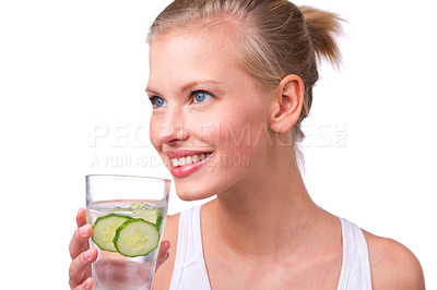 Buy stock photo Shot of a beautiful young woman with a glass of water with cucumber slices isolated on white