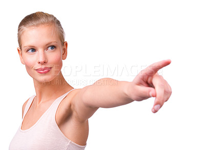 Buy stock photo Shot of a beautiful young woman pointing isolated on white