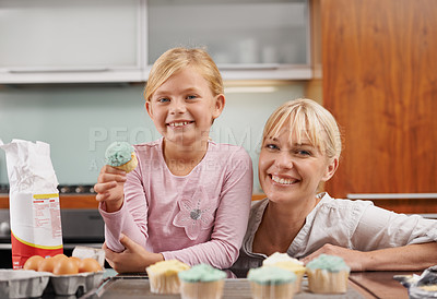 Buy stock photo Happy, mom and child with cupcake in kitchen and learning about baking together in home to relax. Family, bonding and kid smile with mother, excited for eating cake, sweets or enjoy food in house