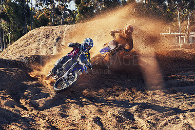 Buy stock photo Shot of a motocross rider chasing down the competitor in first place