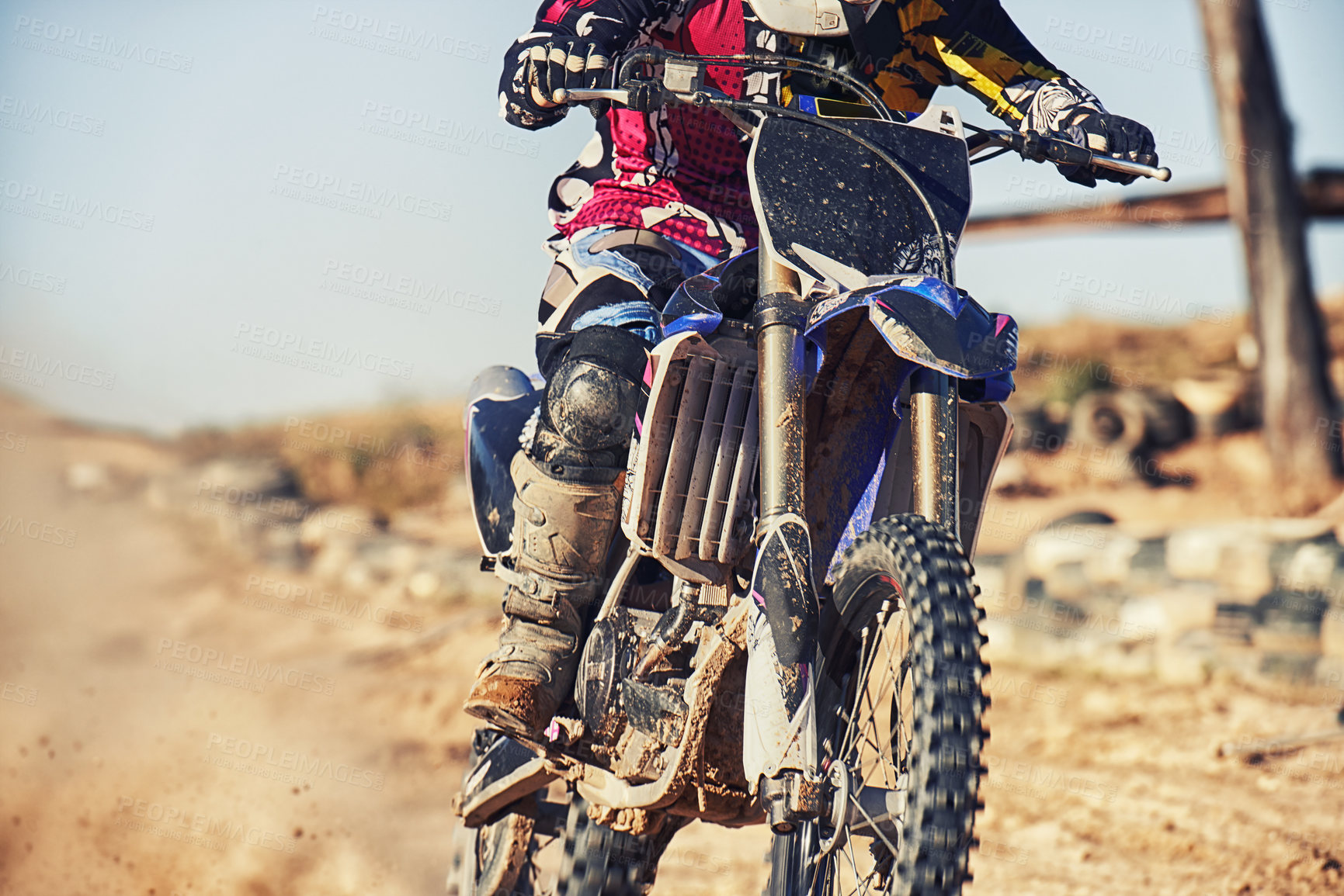 Buy stock photo Person, motorcyclist and track with dirt bike for race, extreme sports or outdoor competition. Closeup or legs of expert rider on motorbike, scrambler or sand course for off road rally challenge