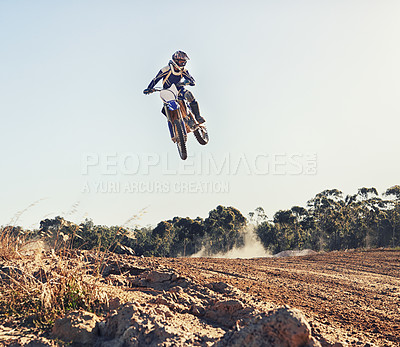 Buy stock photo Person, jump and motorbike of professional motorcyclist in the air for trick, stunt or race on outdoor dirt track. Expert rider on bike or scrambler in dunes or extreme sport with blue sky background