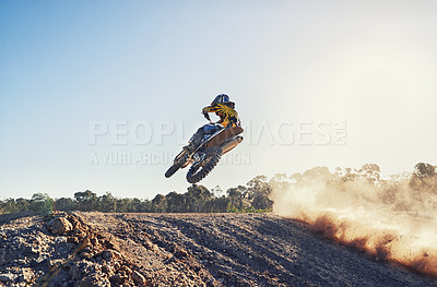 Buy stock photo Person, jump and sports motorcyclist in the air for trick, stunt or race on outdoor dirt track. Rear view of expert rider on motorbike or scrambler in extreme adrenaline with blue sky on mockup space