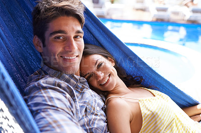 Buy stock photo Portrait of an affectionate young couple lying in a hammock