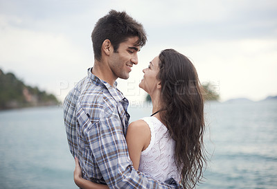Buy stock photo Love, smile and couple at ocean for vacation, holiday or travel together in summer. Happy man, woman and hug at sea for connection, care or embrace for bonding on adventure by water outdoor in nature