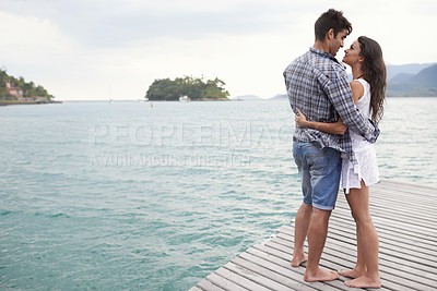Buy stock photo Date, holiday and couple hug by lake in vacation, water and outdoor for nature in summer for romance. Partners, woman and man together to travel, journey and adventure in ocean for love with embrace