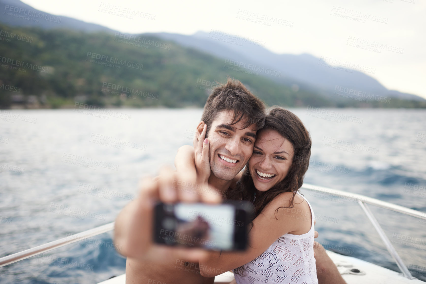 Buy stock photo Couple, vacation and selfie on boat, ocean and Bali for getaway with smile and affectionate. Man, woman and love for phone, happy and travel on yacht and summer holiday by mountain and water