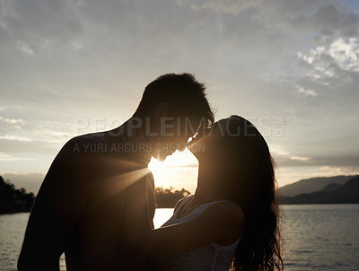 Buy stock photo Silhouette, couple and love by sea at sunset, vacation or travel together in summer. Man, woman and romance at ocean with shadow for connection, relationship and commitment by water outdoor in nature