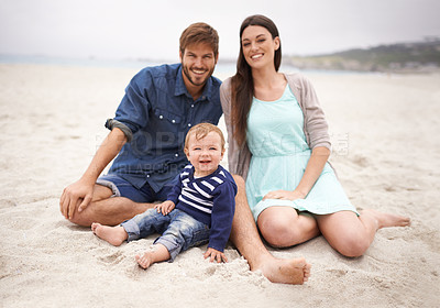 Buy stock photo Portrait, sand and family with smile in beach, mother and father together with cute baby boy for love. Holiday, mom and dad as parents to toddler in nature, growth and development for child outdoor