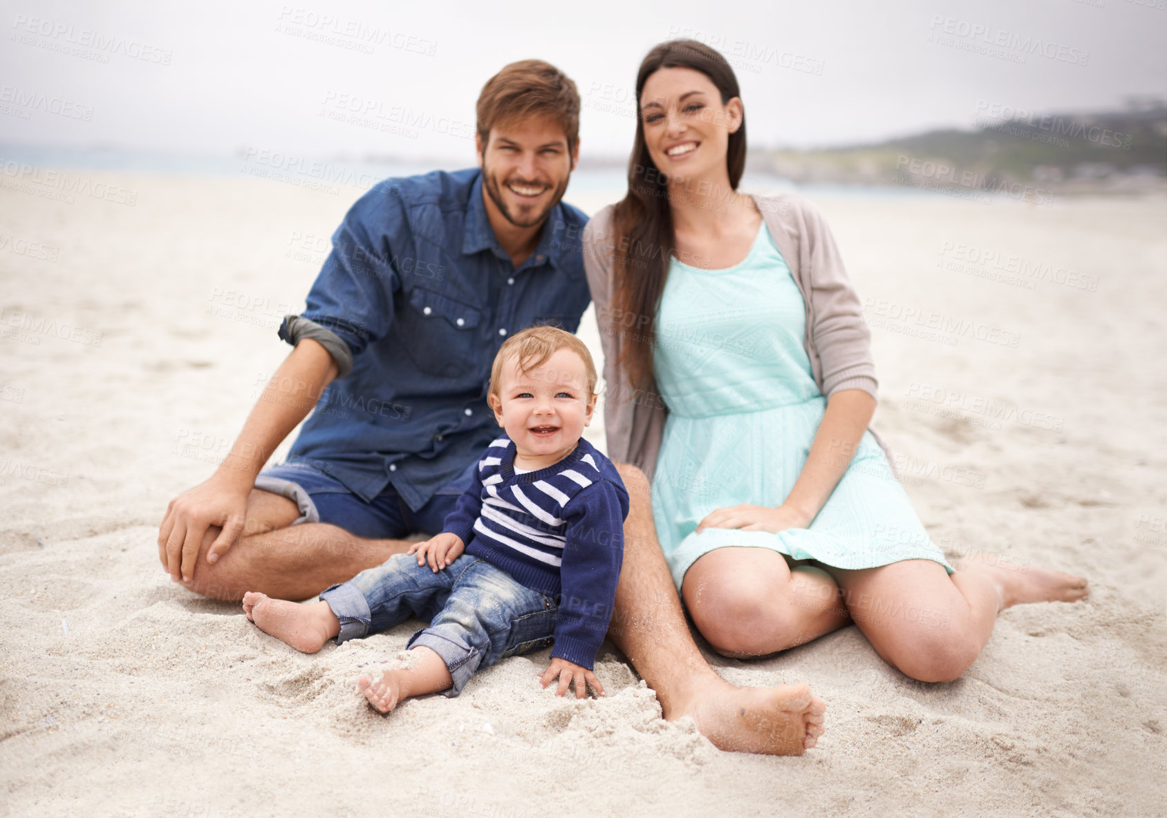 Buy stock photo Portrait, sand and family with smile in beach, mother and father together with cute baby boy for love. Holiday, mom and dad as parents to toddler in nature, growth and development for child outdoor