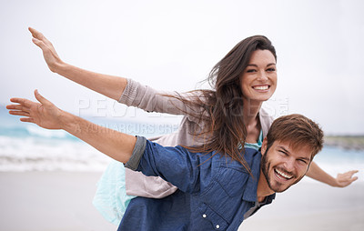 Buy stock photo Airplane, happy and couple with piggyback on beach in summer for love, travel and freedom on vacation in California. Portrait, ocean and face with smile for fun on holiday, trip or adventure together