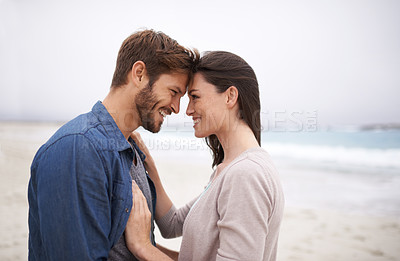 Buy stock photo Cropped shot of a romantic young couple at the beach