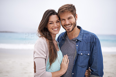 Buy stock photo Cropped shot of a young couple at the beach