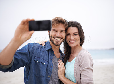 Buy stock photo Selfie, love and couple hug at beach for travel, photo and freedom outdoors together. Smile, embrace and traveling influencer people live streaming for blog, followers or social media profile picture