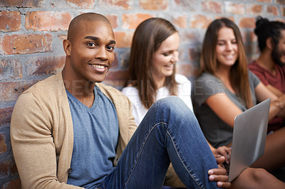 Buy stock photo Shot of a diverse group of friends sitting in a hallway