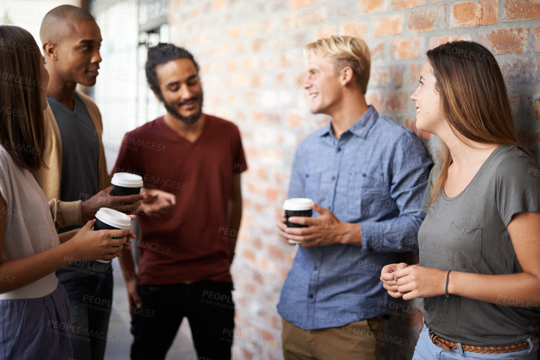 Buy stock photo Coffee, friends and students talking in a college hallway for discussion, happiness and a drink. Group of diversity men and women at campus or university for conversation about education and learning