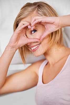 Buy stock photo Portrait, woman and hand with heart on eye for vision, motivation or kindness with support emoji. Smile, person and happiness with love symbol for hope, care sign and trust gesture for wellness