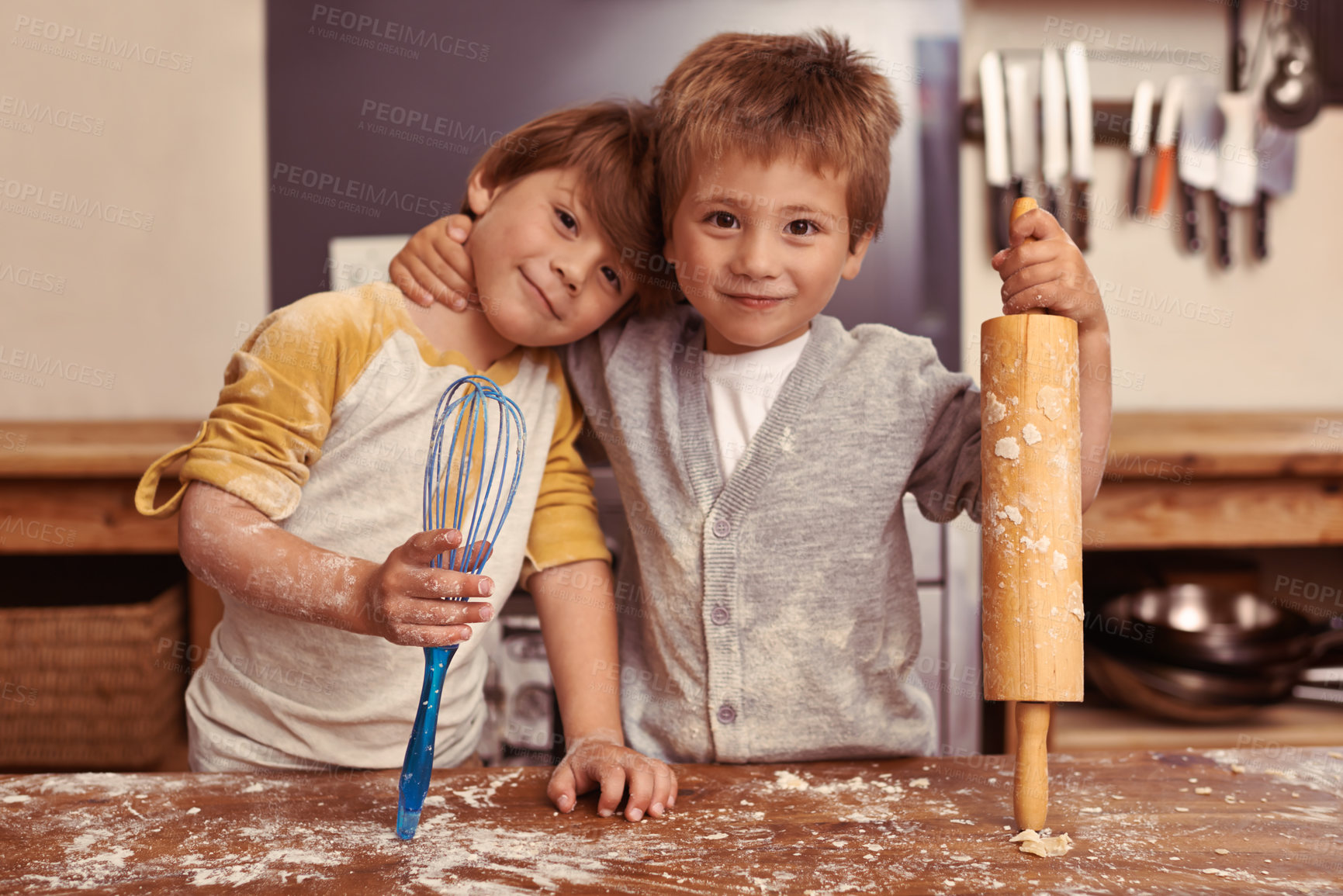 Buy stock photo Cropped shot of two young brothers baking in the kitchen