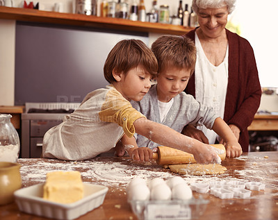 Buy stock photo Grandma, smile and children baking in kitchen, learning or happy boys bonding together in family home. Grandmother, kids and cooking with flour, rolling pin or teaching brothers with dough at table